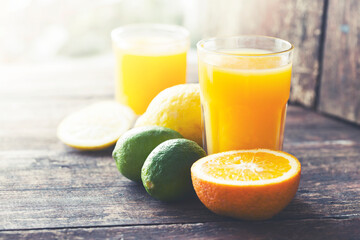glasses of fresh Orange juice over rustic wooden background 