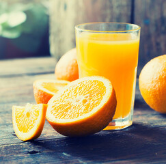 glasses of fresh Orange juice over rustic wooden background 
