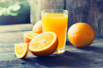 glasses of fresh Orange juice over rustic wooden background 