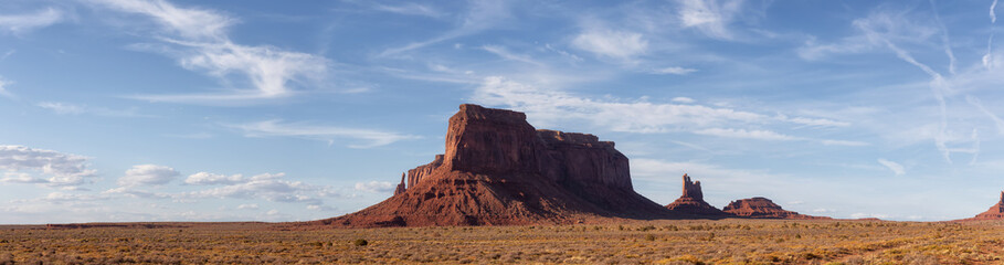 Fototapeta na wymiar Desert Rocky Mountain American Landscape. Sunny Blue Sky Day. Oljato-Monument Valley, Utah, United States. Nature Background Panorama