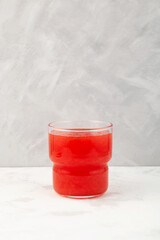 Glass of Watermelon smoothie or watermelon juice on grey background. Jus semangka