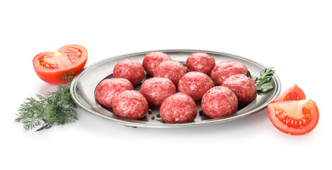 Plate with raw meat balls, tomato slices and dill on white background