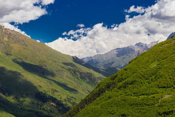 Naklejka na ściany i meble Beautiful mountain landscape. Alpine climbing. Sunset in the mountains. The Caucasus is a region spanning Europe and Asia. Elbrus region. Mountains landscape. 