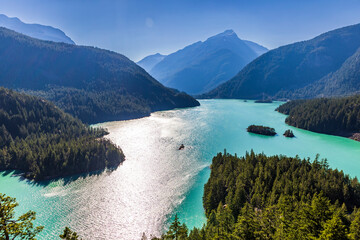 turquoise colored lake of Diablo Lake surrounded by towering mountains in North Cascade National...