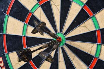 Den Helder, Netherlands. August 2022. The three darts in the bullseye of the dartboard.