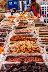 dried fruits in baskets in a local market .