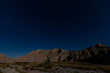 Fototapeta na wymiar rugged rock formations under the clear night stars in Badlands national park in South Dakota