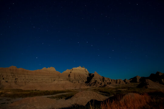 rugged rock formations under the  clear night stars in Badlands national park in South Dakota