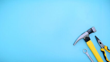 different type of yellow and black hand tools flat lay isolated baby blue background with copy space 