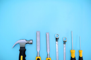 different type of yellow and black hand tools flat lay isolated baby blue background with copy space 