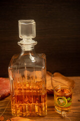 Costa Rican rum served in a shot glass with a frog image, on a wooden table with dry leaves