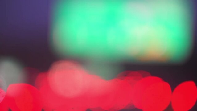 Night illuminated abstract red and blue colors from traffic cars road with bokeh blurry circles moving shaky footage driving point of view