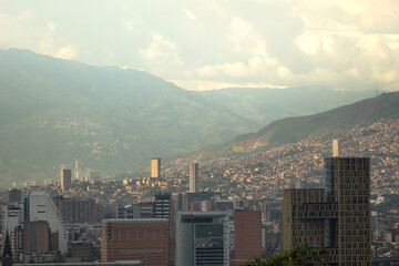 Obraz premium Skyline of a city during a sunset with many buildings and mountains in the background. Medellin Colombia