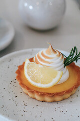 Lemon meringue tart pastry with citrus fruits. Delicious, appetizing, homemade dessert with lemon curd cream.