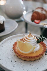 Lemon meringue tart pastry with citrus fruits. Delicious, appetizing, homemade dessert with lemon curd cream.