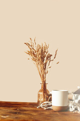 Autumn scene layout. a cup of coffee, wooden cutting boards and dried flowers in the sunlight. Autumn kitchen composition. Thanksgiving, Halloween.