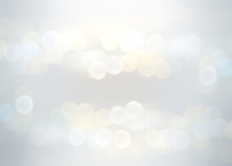 Light subtle bokeh flares on airy white blur background for wedding event. Delicate shiny pure backdrop. 