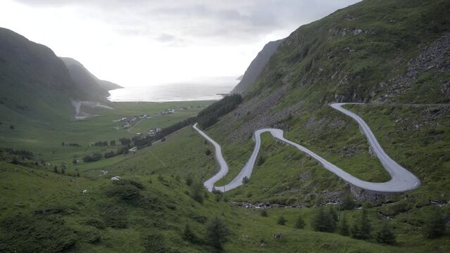 Majestic winding road leading to Hoddevik surf beach in Norway, handheld view