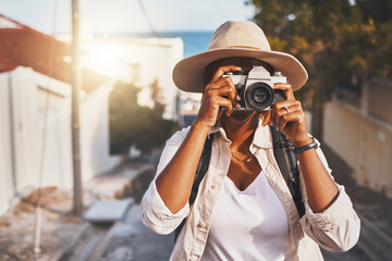 Photographer, travel or tourist taking pictures or photos outdoors in a new town. Traveler using a...