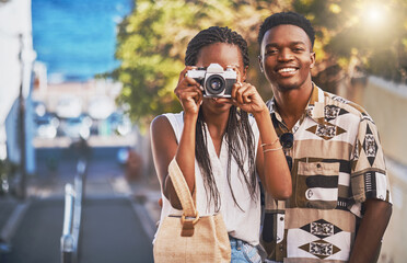Travel, tourism and young black couple taking photo on a camera, having fun and walking in a city....