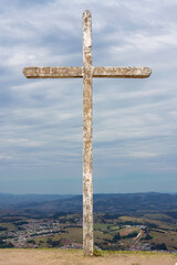 Old White Cross on the hill with a very clody and greyd blue skye on Morro Pelado at Aguas de Lindoia - Brazil