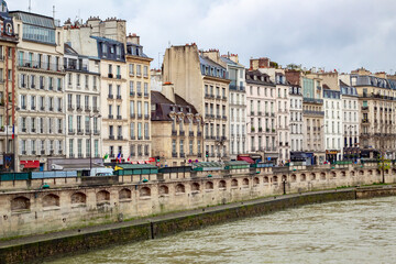 View of French Paris buildings architecture along the Seine River on a cold cloudy winter day