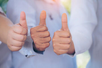 Thumbs up team hand satisfaction job with positive happy good sign. Close up business people partner hand Positive idea good sign. Teams trust Gesture sign Thumbs up together as teamwork partnership