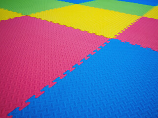 Colorful floor tiles in play room. - Powered by Adobe