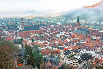 Fototapeta premium City view of Heidelberg Germany red city historic architecture from Heidelberg Castle on a cloudy winter day