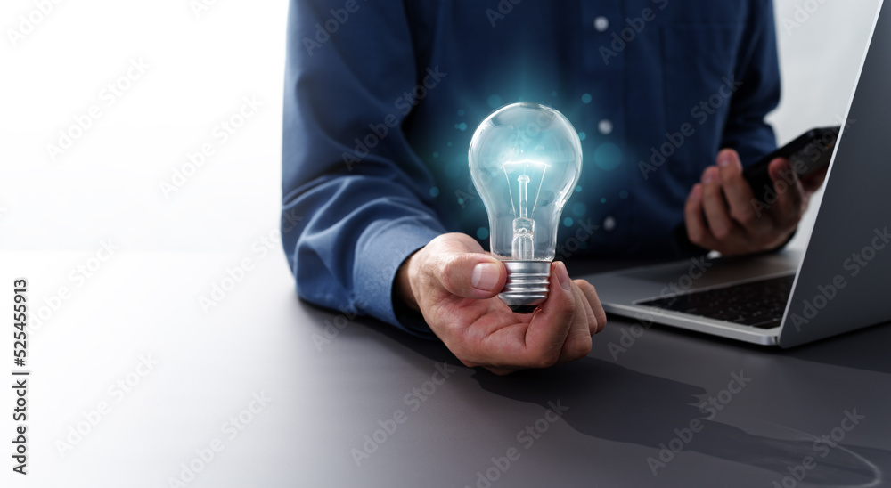 Poster business inspiration and solution image.man holding lightbulb. using smartphone and laptop.