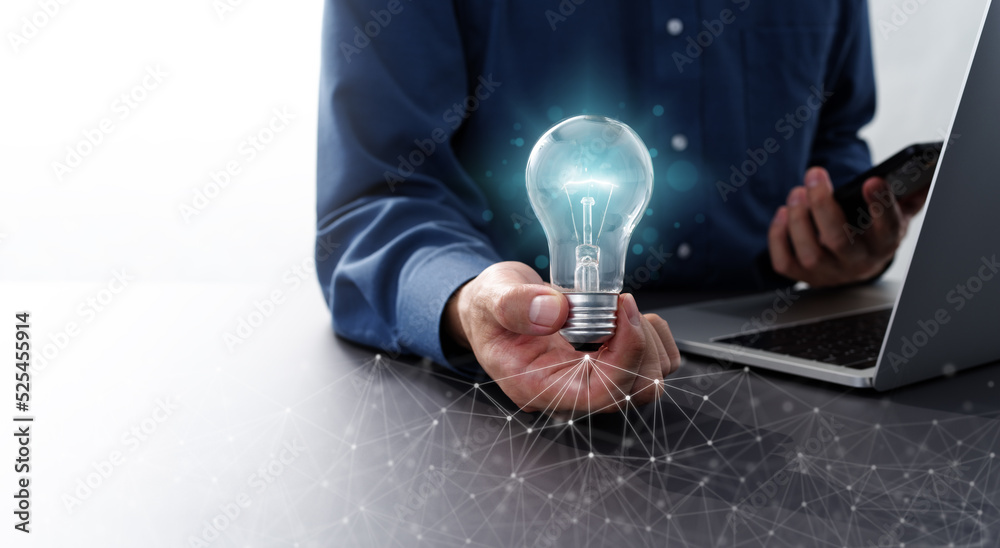 Fototapete Network technology and business idea image. Man holding lightbulb and smartphone. Laptop and computer network.
