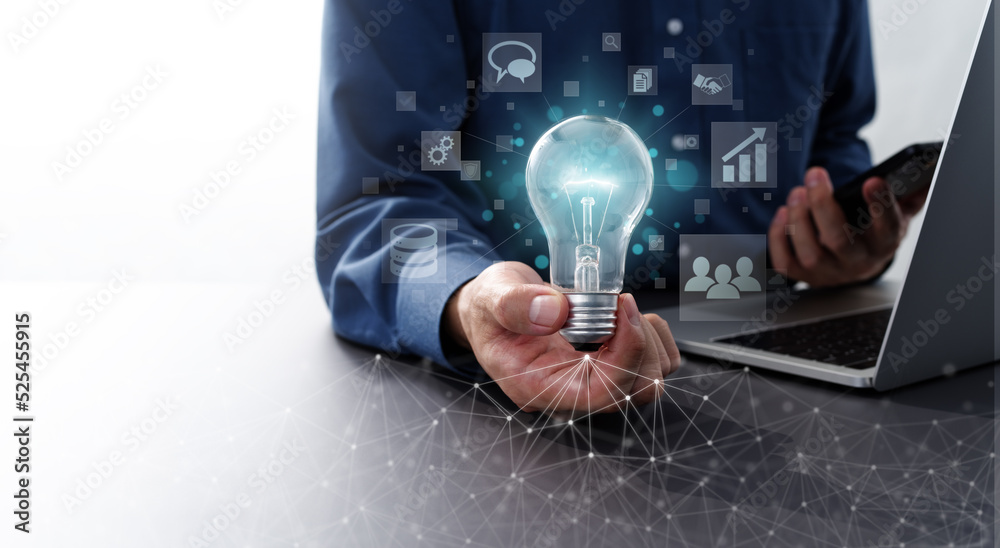 Fototapete Network technology and business solution image.  Man holding lightbulb and smartphone. Laptop and computer network.