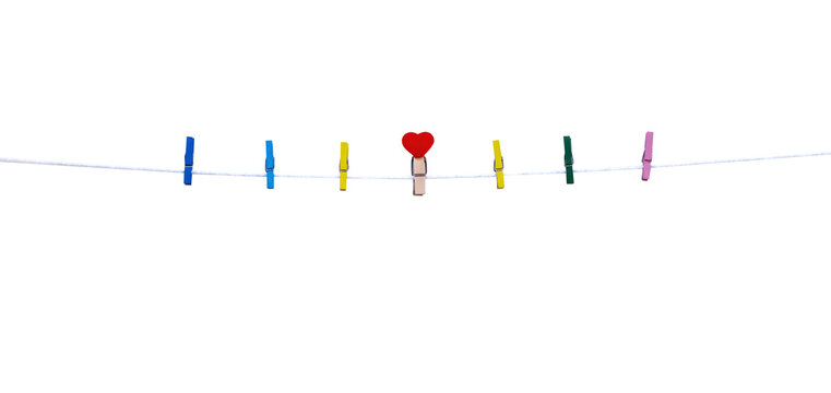 Wood clothes seven clip with red heart shape patterns in the middle hanging on white string line isolated on white background , clipping path	