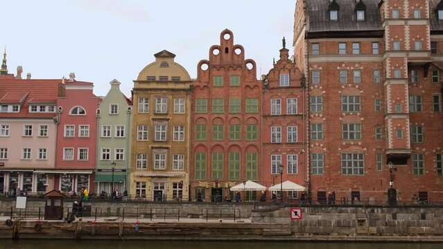 Old town in Gdansk. The riverside on Granary Island reflection in Moltawa River Cityscap. Ancient crane at dusk. Visit Gdansk Poland Travel destination. Tourist attraction
