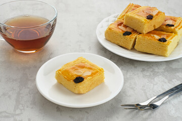 Lekker holland or dutch butter cake (boterkoek), made of butter, flour, eggs and sugar with a sprinkling of sliced ​​almonds and raisins
