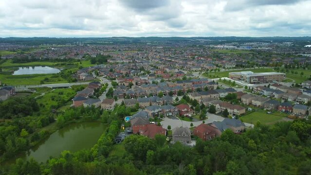 Aerial view of suburban neighborhood, flying right and slowly panning