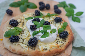 pizza with berries, mozzarella cheese and basil