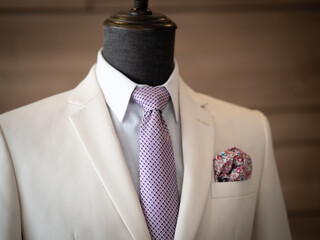 Close up of white tuxedo suit with white shirt, black button and black handkerchief