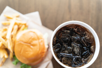 Burger and fries served with a ice cold Cola drink