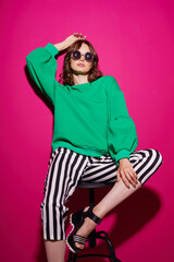 Fashion asian female model in green trendy sweater and pants.