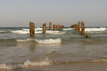 Rusty pillars of an old pier on the Mediterranean coast near Caesarea
