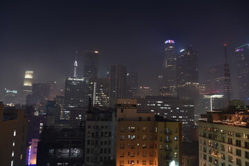 City Night skyline with fog and haze above the buildings of cyberpunk