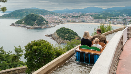 FAMILY ENJOYING BEAUTIFUL VIEWS OF LA CONCHA BEACH ON A CLOUDY DAY
