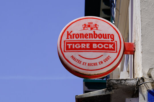 Kronenbourg tigre bock logo and brand text on beer round sign on facade wall bar pub building restaurant