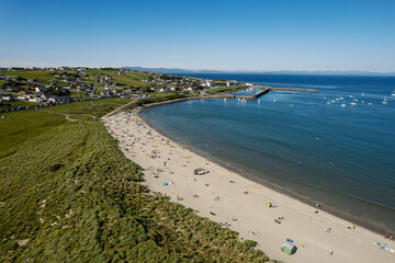 Stunning sandy beach and blue ocean and sky. Aerial view. Mullaghmore town area in county Sligo, Ireland, Popular travel destination with beautiful nature scenery and water sports. Warm sunny day.