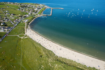 Stunning sandy beach and blue ocean and sky. Aerial view. Mullaghmore town area in county Sligo, Ireland, Popular travel destination with beautiful nature scenery and water sports. Warm sunny day.