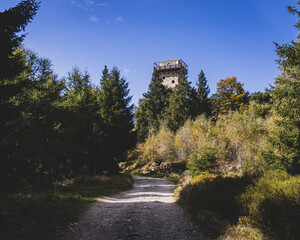 a stone lookout tower on the top of the mountain. hidden behind trees. "high stone"