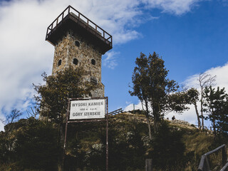 a reconstructed stone lookout tower on the top of the mountain - a high stone