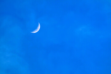 Obraz na płótnie Canvas New moon over the blue sky