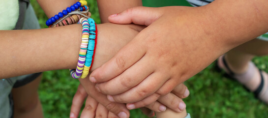 The children put their hands together. Selective focus.